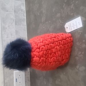 Mischa lampert winter hat orange with navy puff.